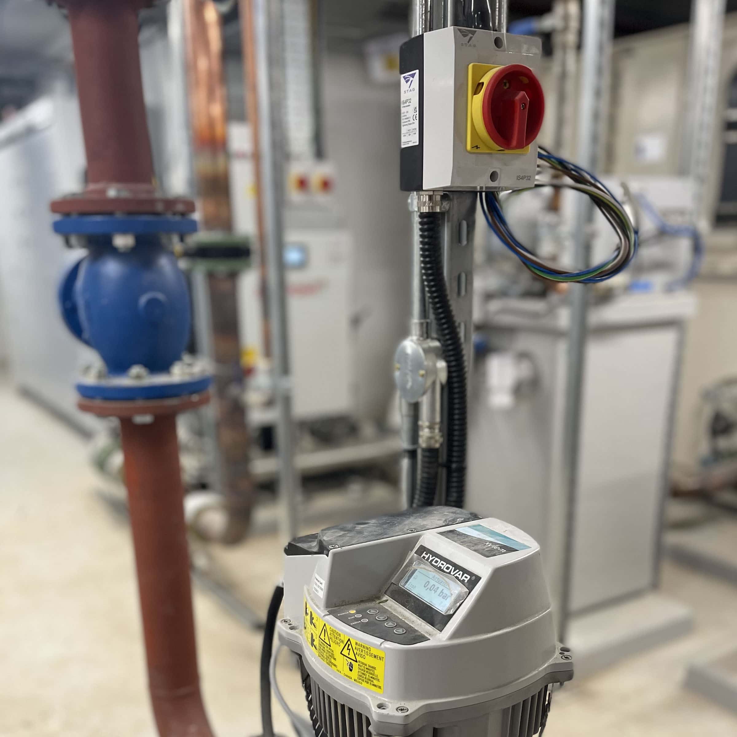 Industrial control panel and piping in mechanical room.